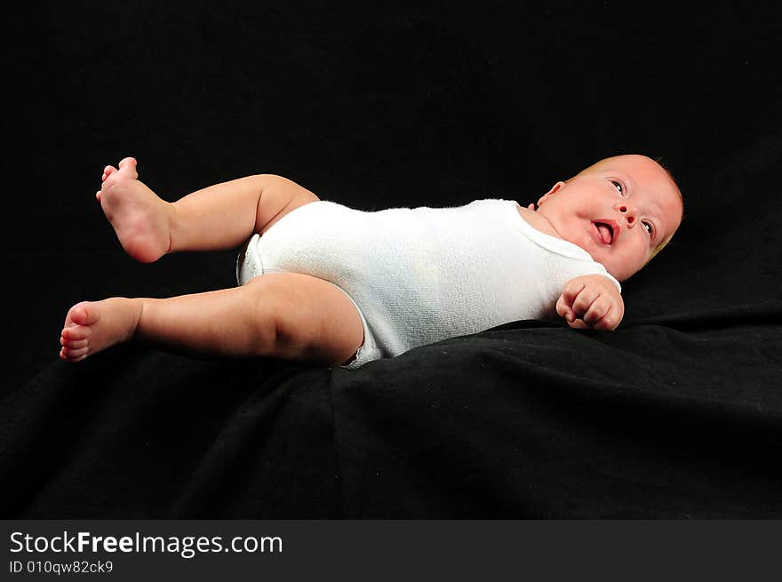 Baby boy isolated over black