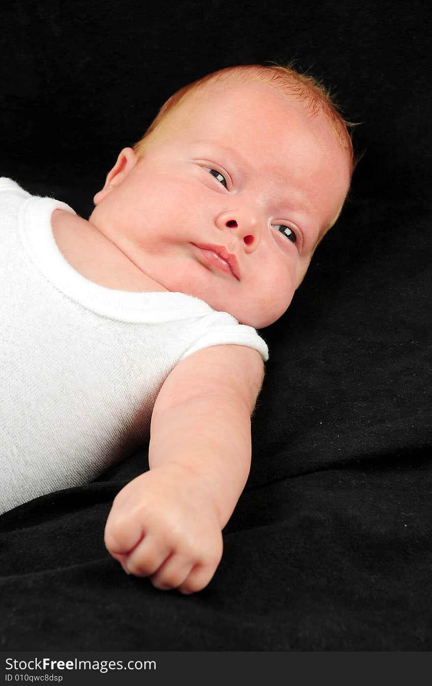 Baby boy isolated over black