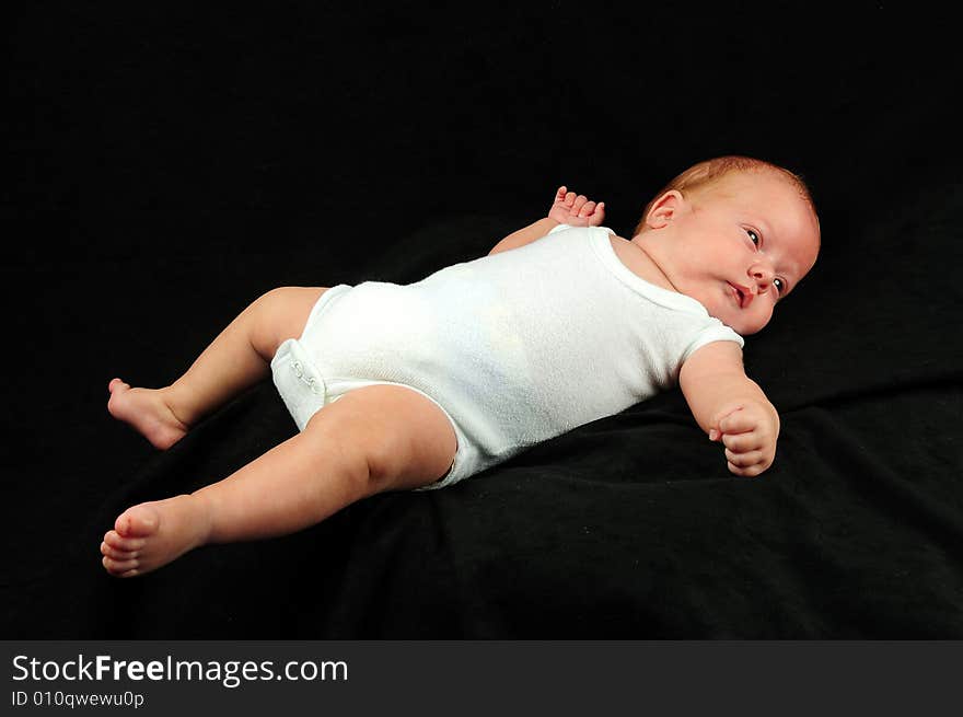 Baby boy isolated over black