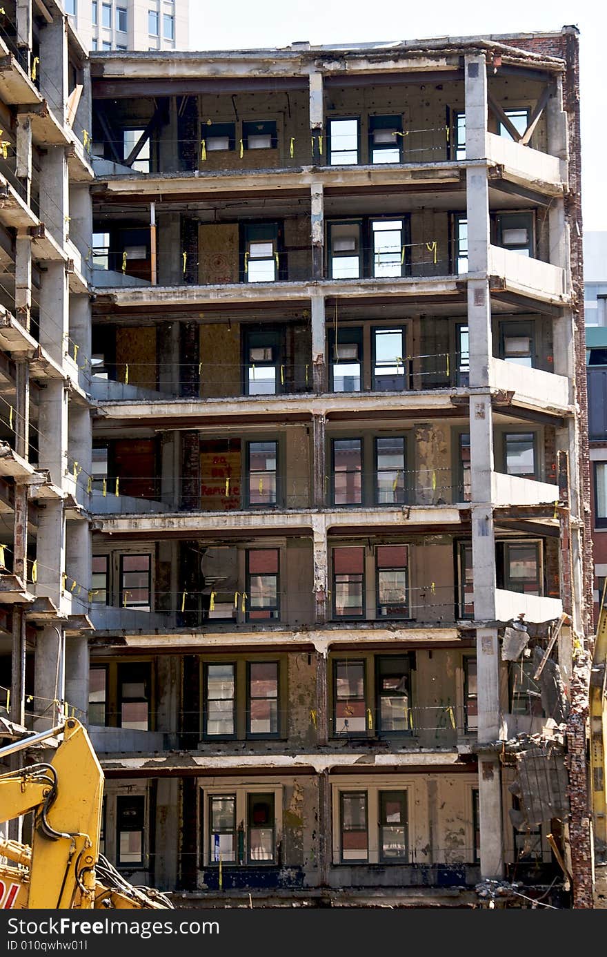 View of deconstruction site showing open shell of building as it is being torn down