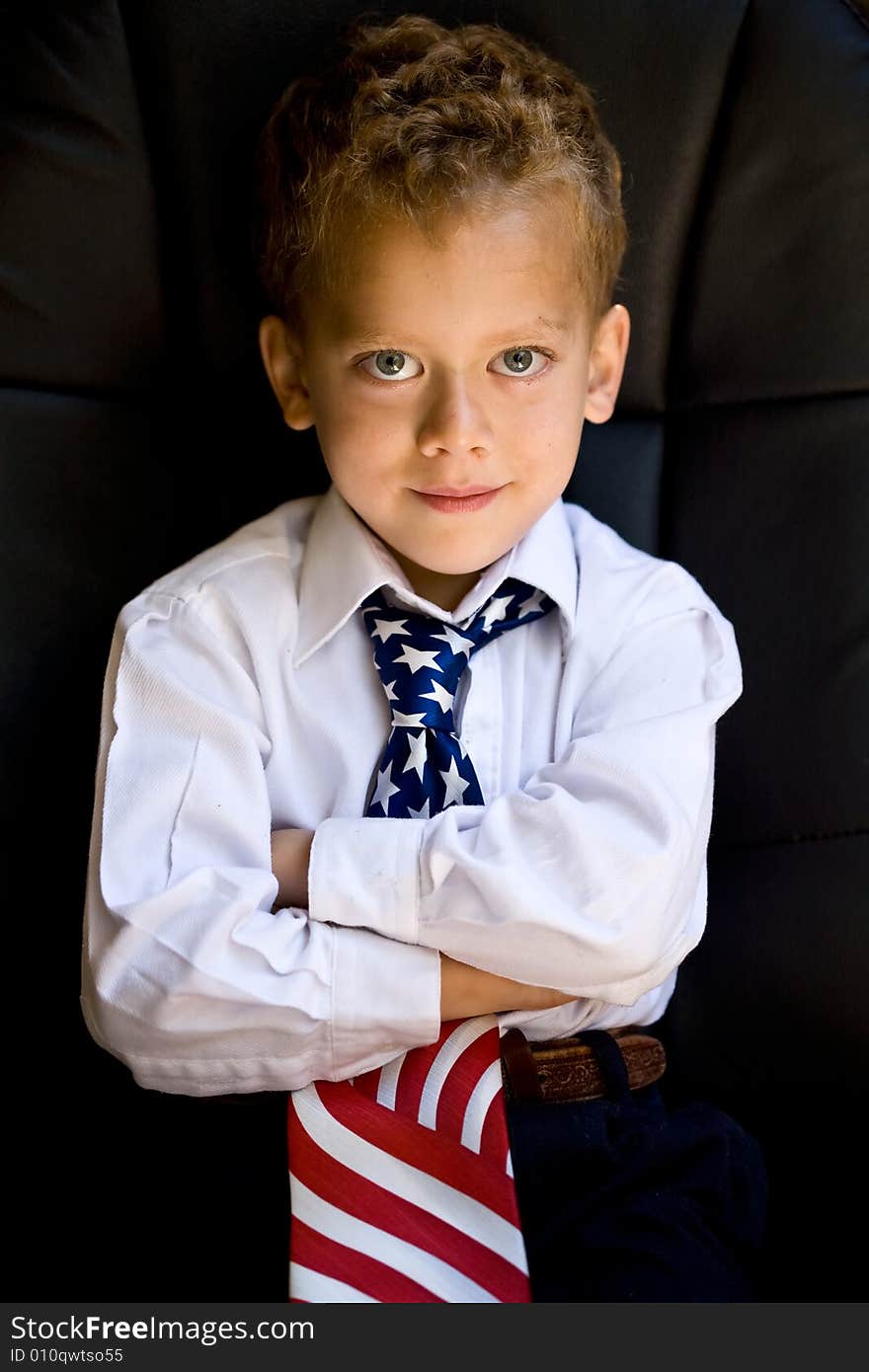 A portrait of young boy wearing US flag necktie. A portrait of young boy wearing US flag necktie