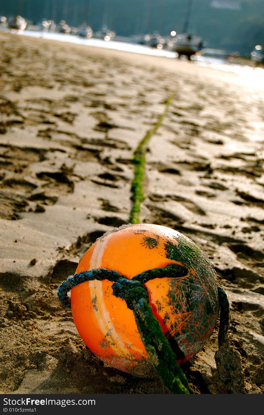 Orange bouy with in the sand on a hot day. Orange bouy with in the sand on a hot day