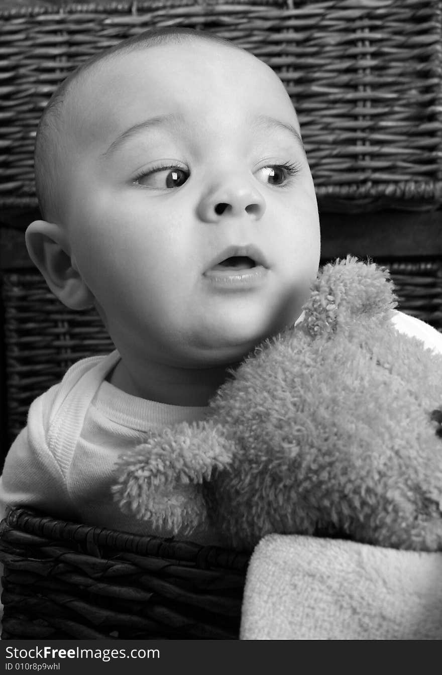 Six month old baby sitting infront of wooden drawers. Six month old baby sitting infront of wooden drawers