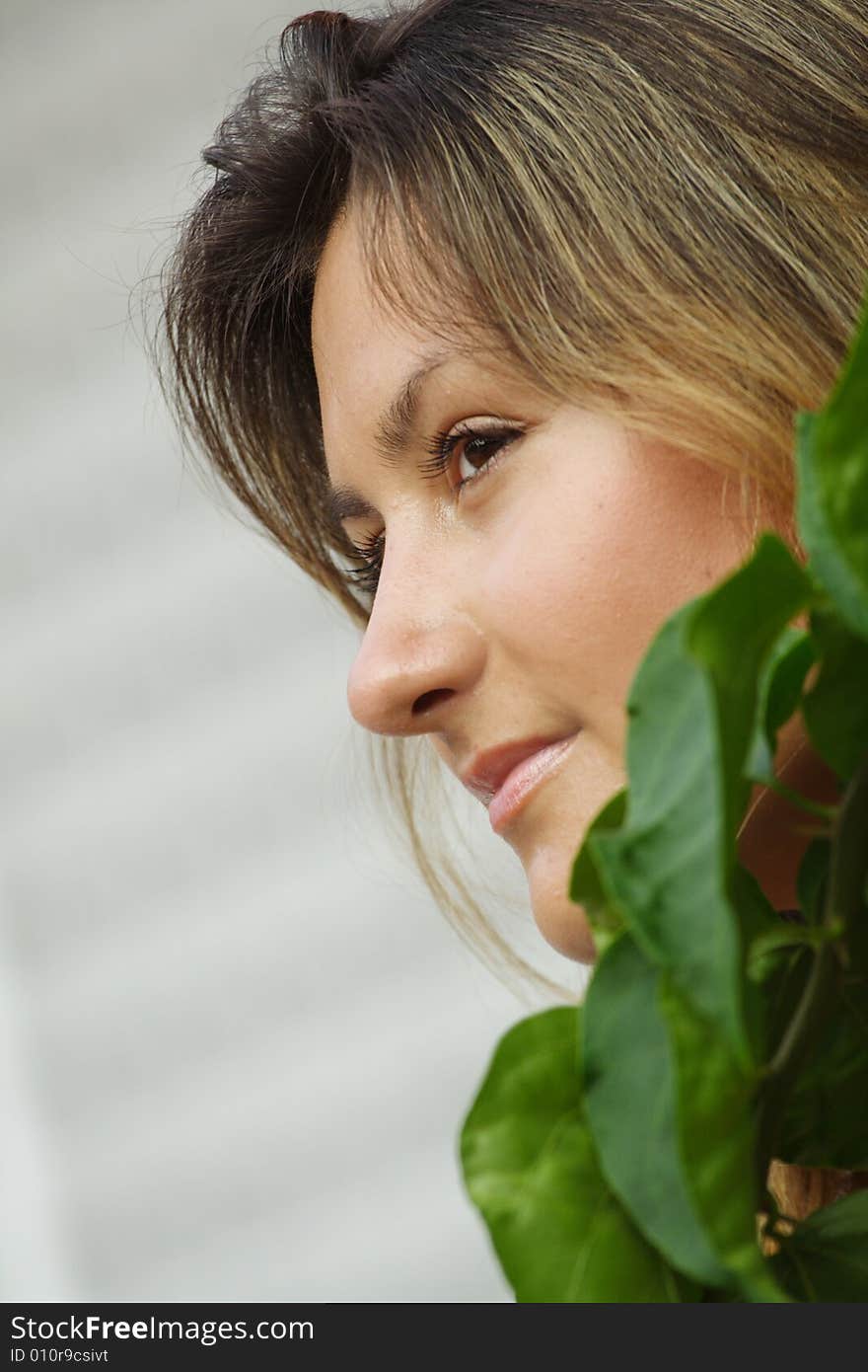 Woman with Green Leafs in Foreground