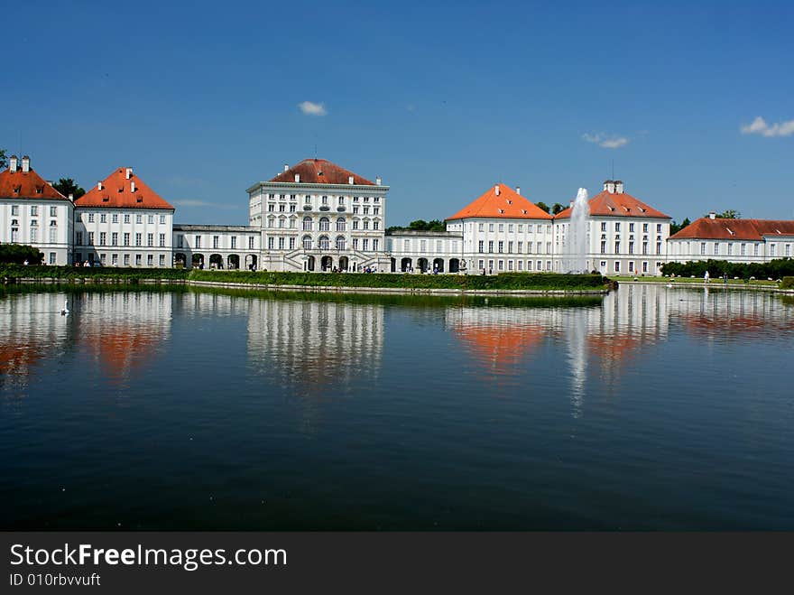 Bavarian palace with fountain and green green plantations