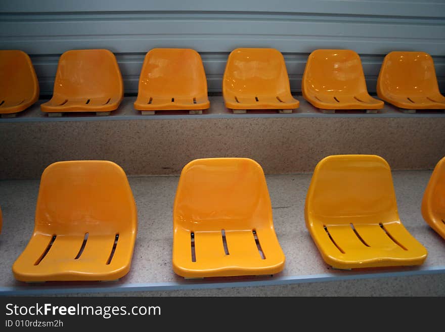 Rows of the empty stadium yellow seats. Rows of the empty stadium yellow seats.