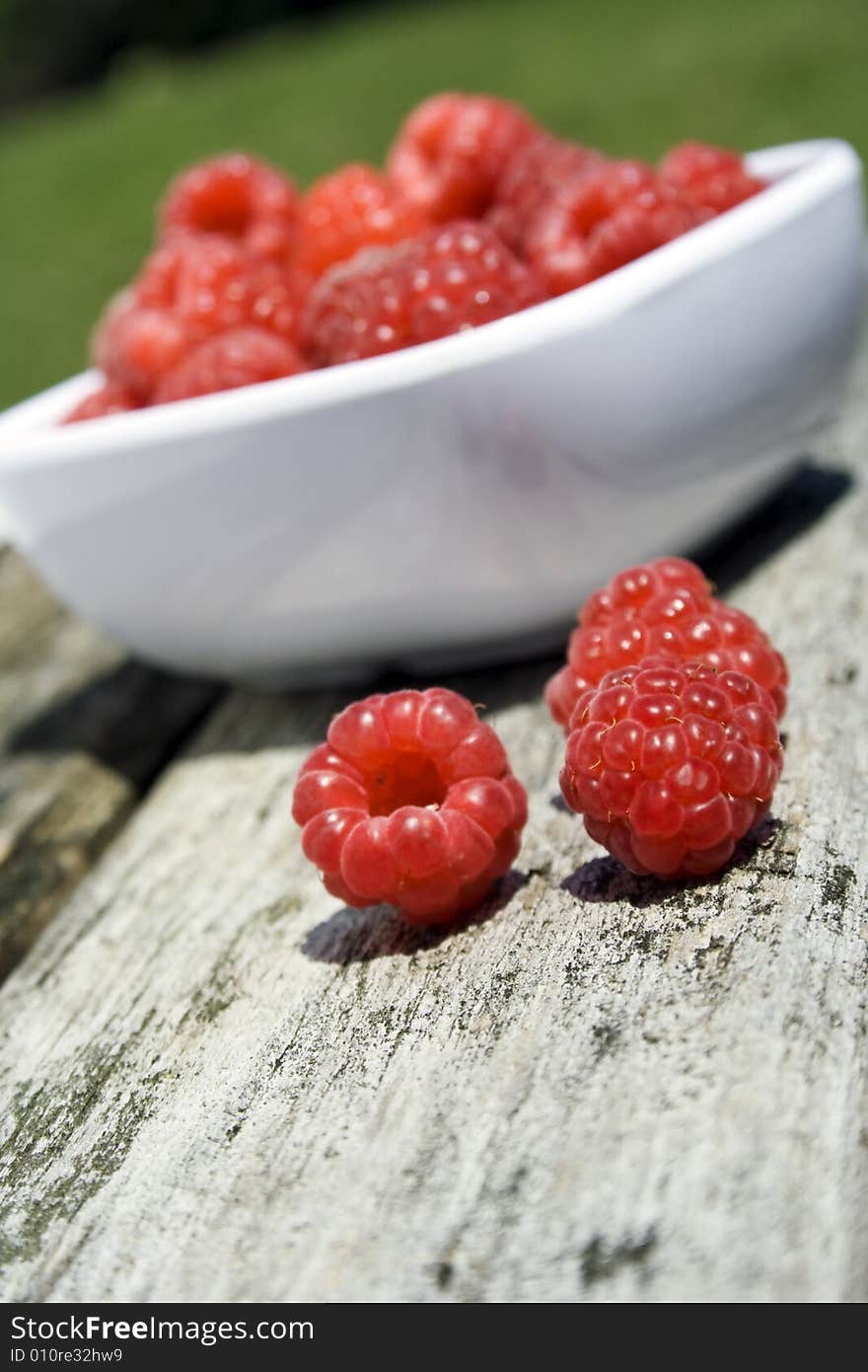 Red raspberries in white bowl