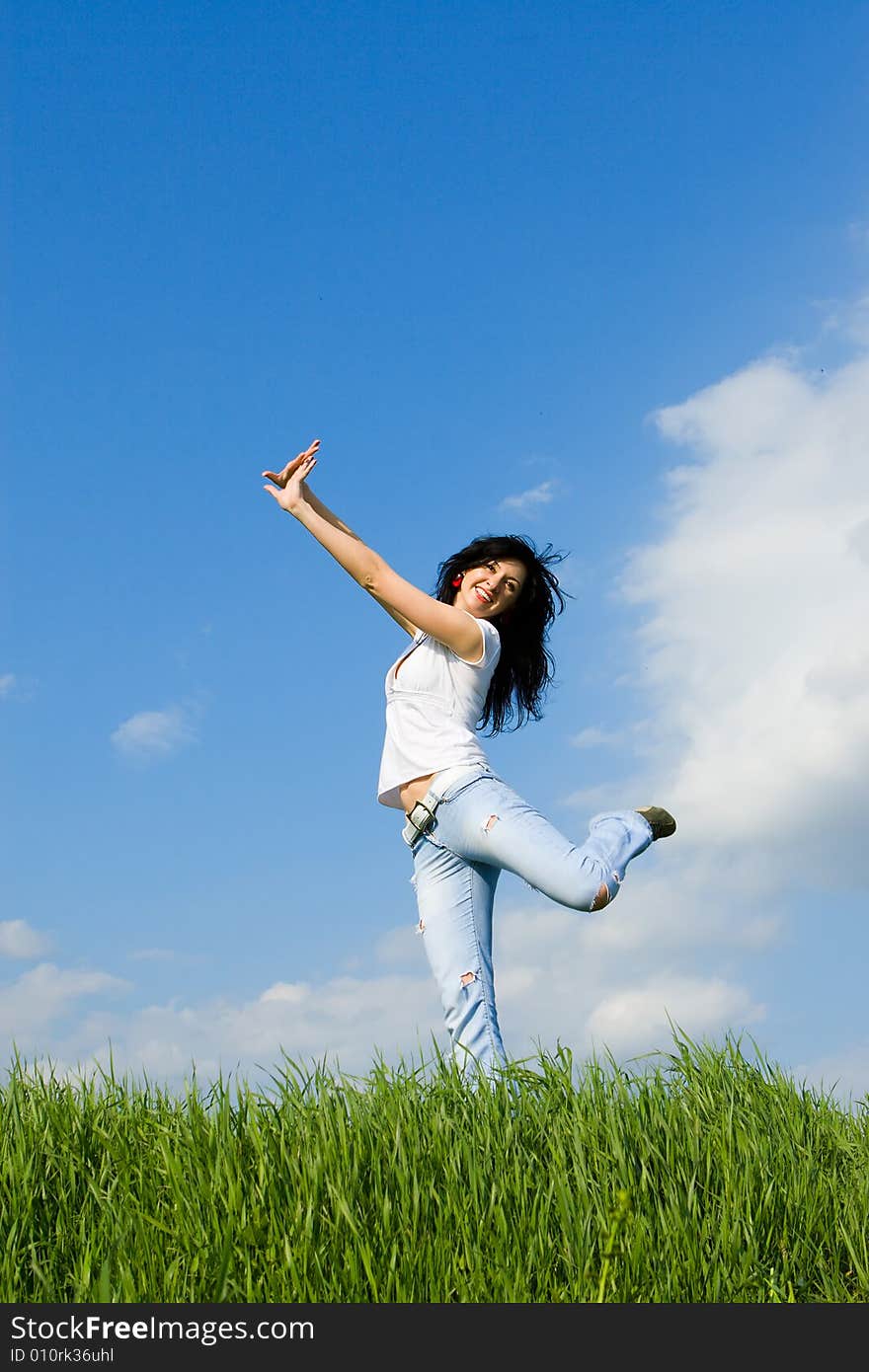 Expressive young woman is jumping