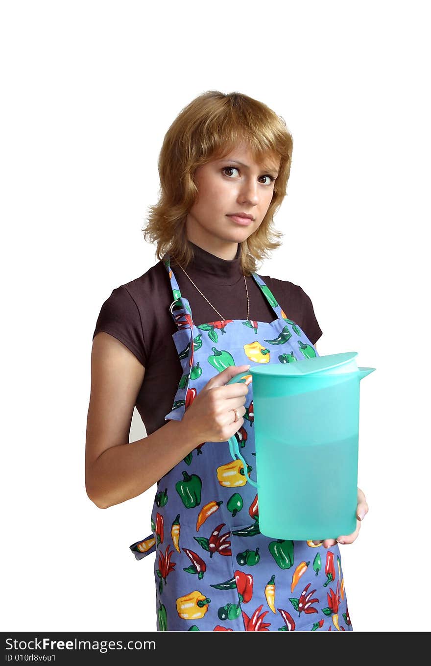 The young girl in an apron with a jug of green color on a white background. The young girl in an apron with a jug of green color on a white background.