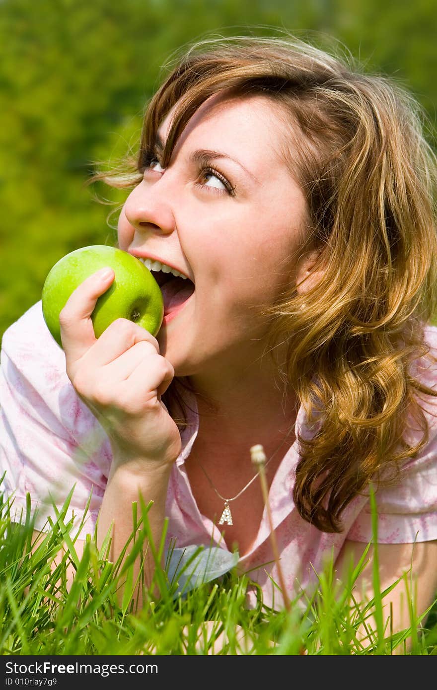 Pretty woman eating green apple