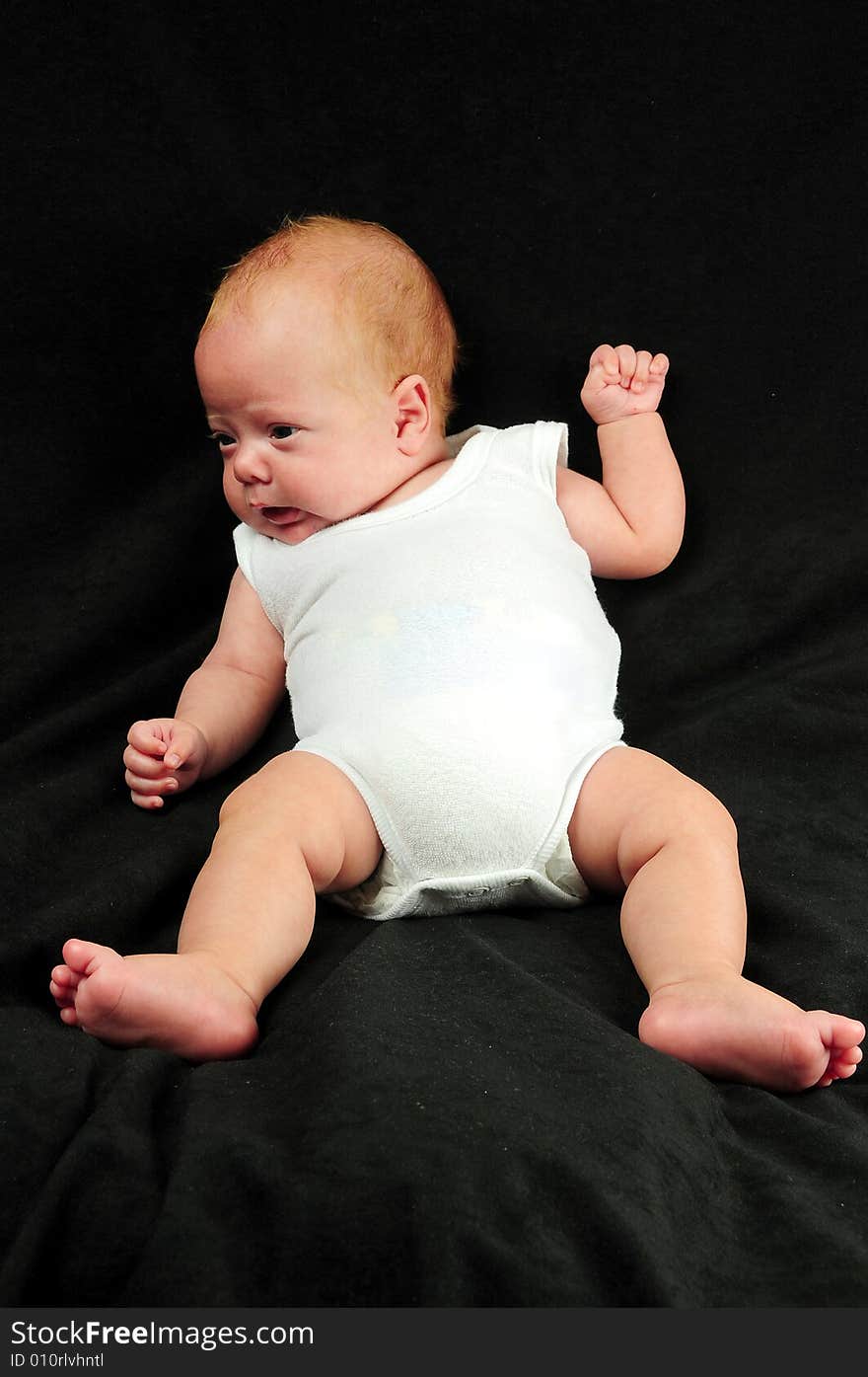 Baby boy isolated over black