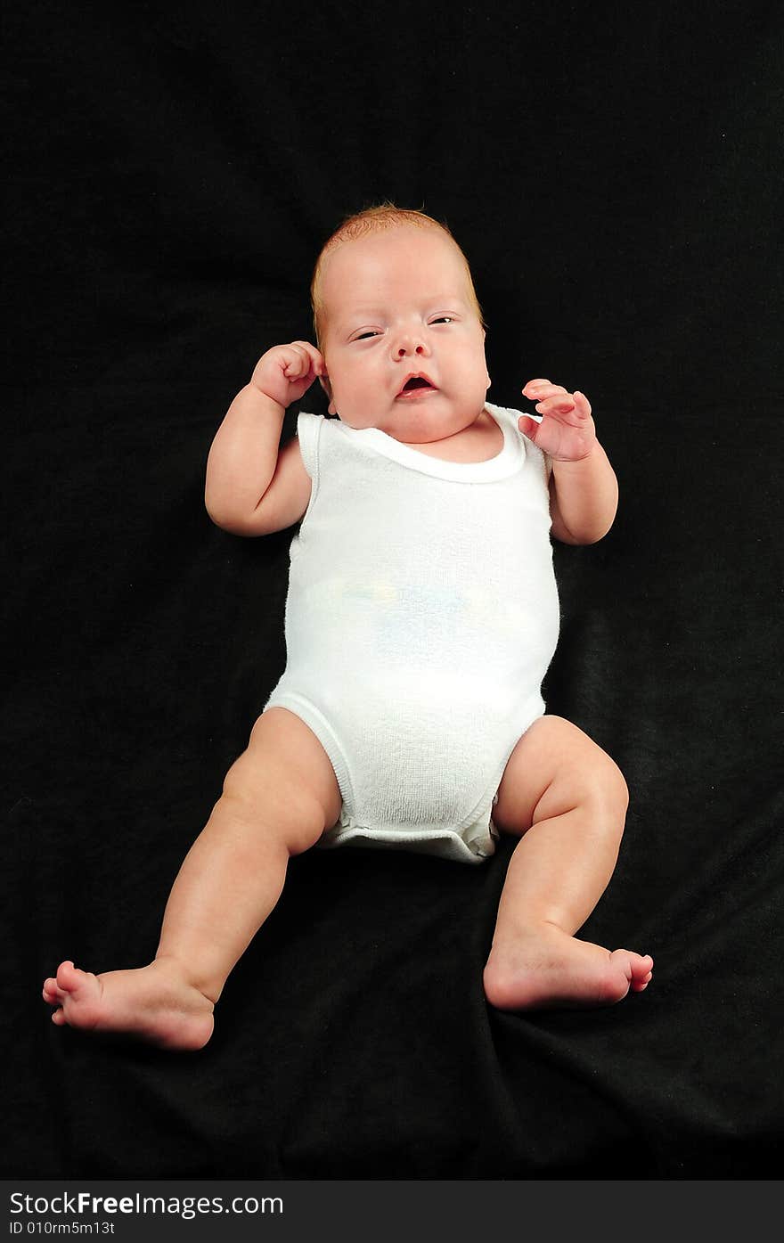 Baby boy isolated over black