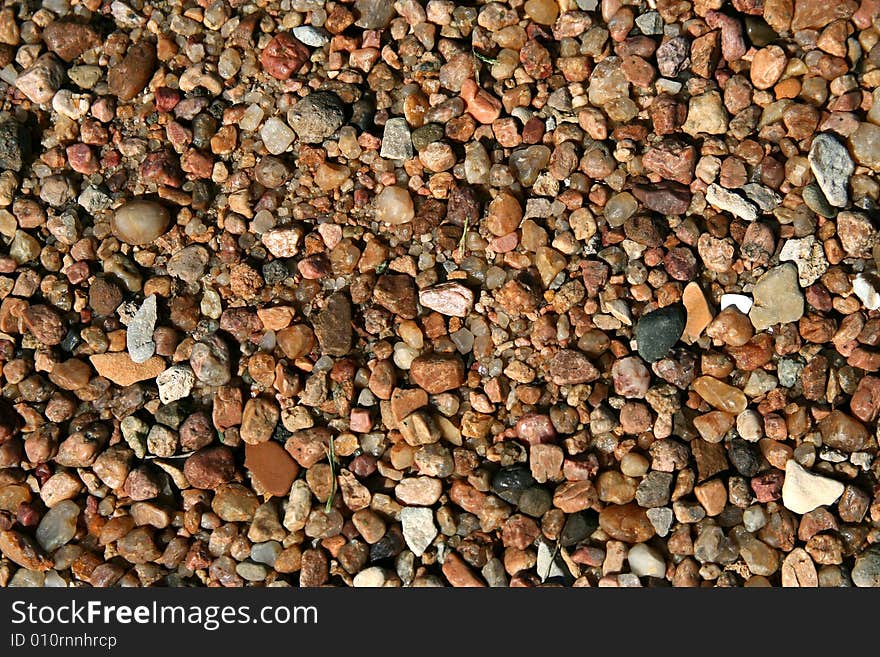 A cluster of pebbles forms an abstract background. A cluster of pebbles forms an abstract background.