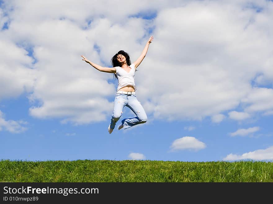 Expressive young woman is jumping