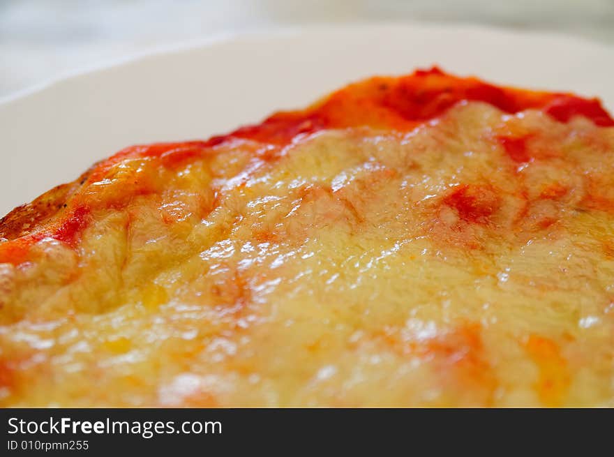 Close shot of a little tomato and mozzarella pizza