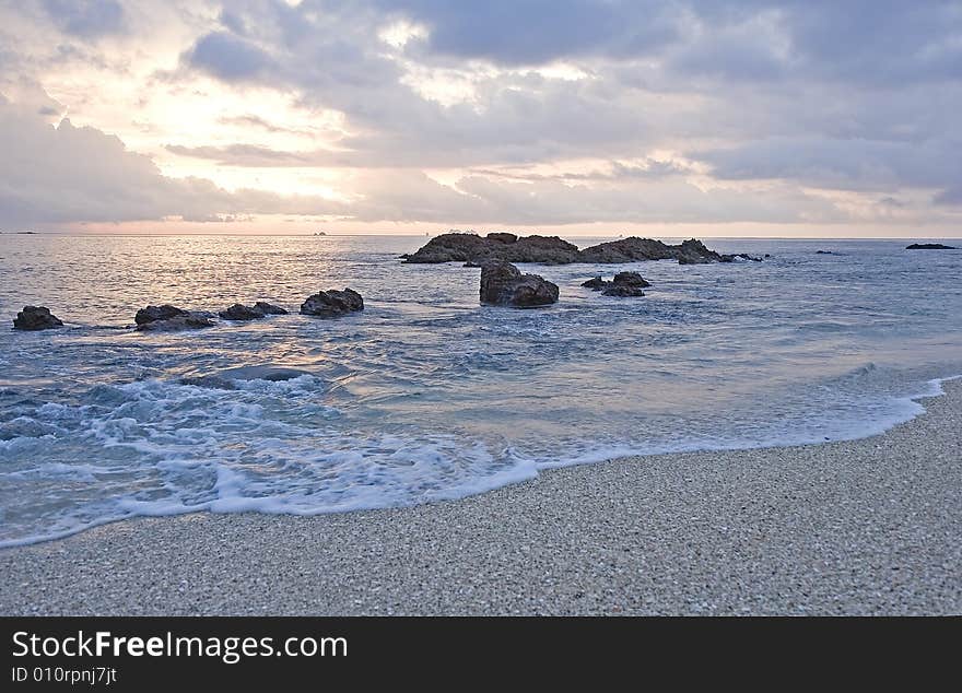 Sunset On Rocky Surf