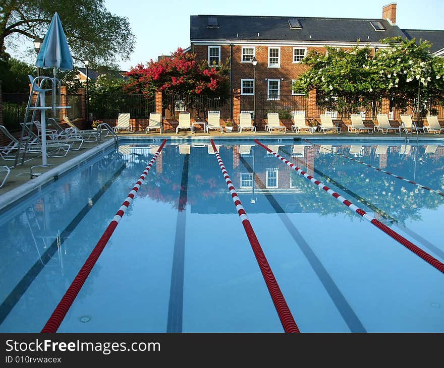 Photo of swimming pool in the early morning hours before opening. Photo of swimming pool in the early morning hours before opening.