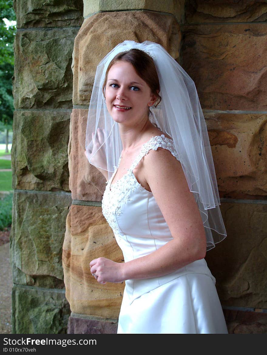 View of bride on stone porch. View of bride on stone porch