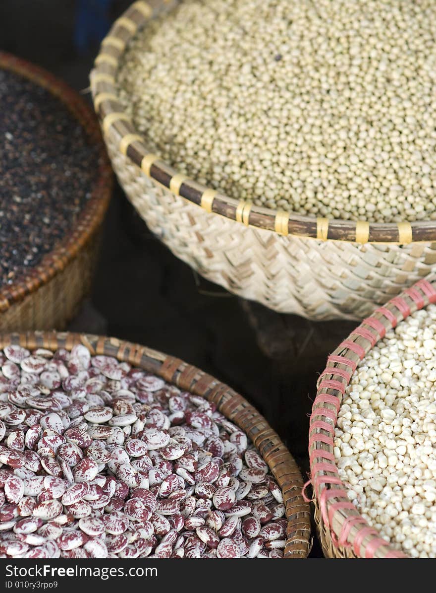 Assortment of beans and seeds in baskets at a market. Photo taken in Hanoi, Vietnam. Shallow depth of field with the seeds in the front in focus. Assortment of beans and seeds in baskets at a market. Photo taken in Hanoi, Vietnam. Shallow depth of field with the seeds in the front in focus.