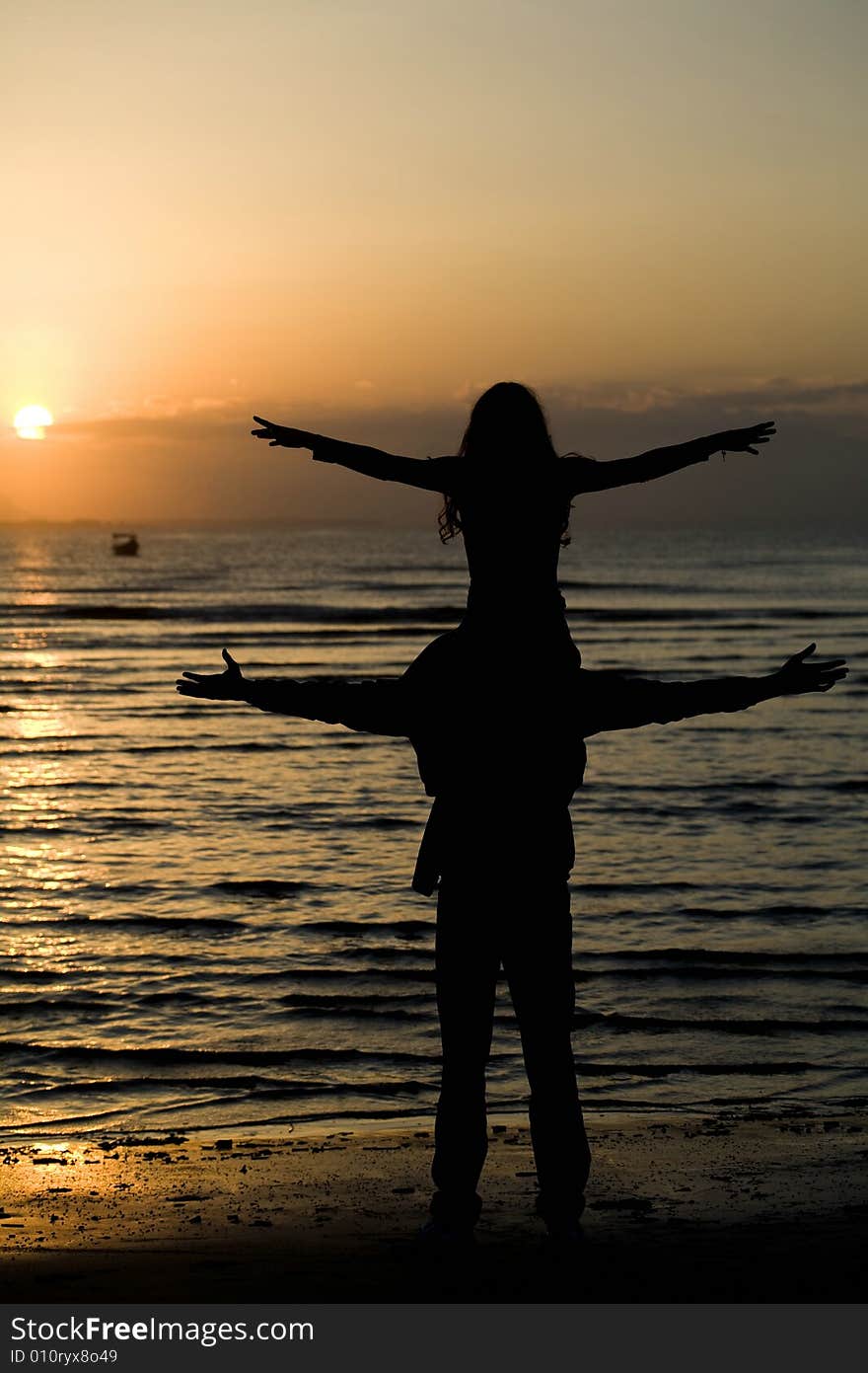 A silhouette of a couple on the beach. A silhouette of a couple on the beach.