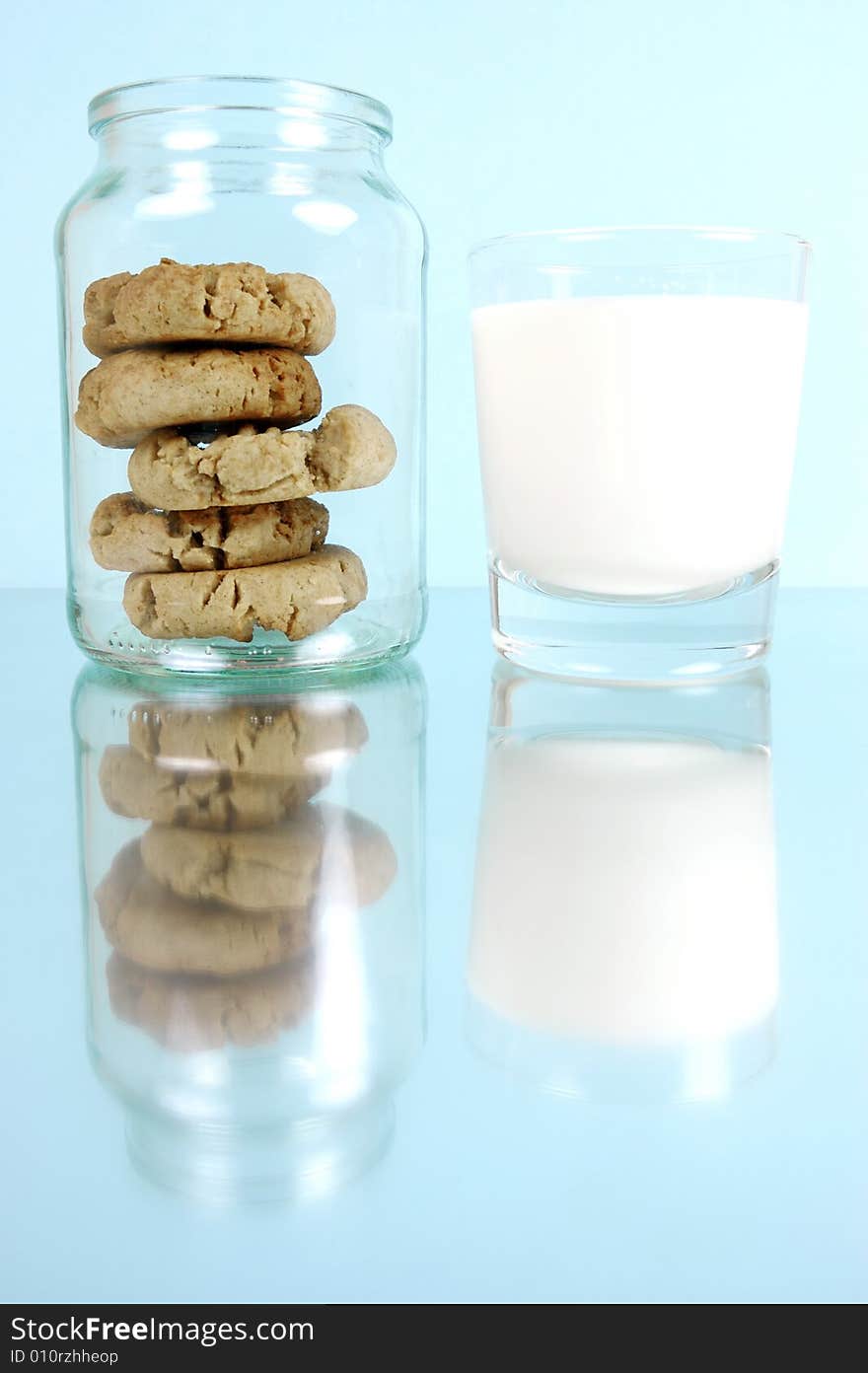 Milk and cookies isolated against a blue background