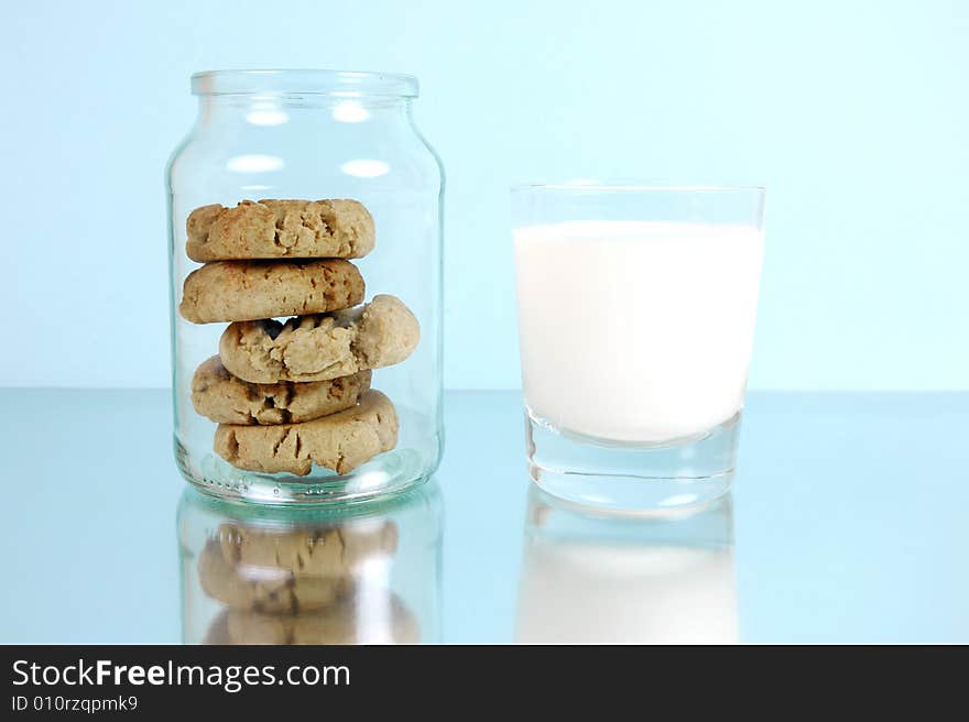 Milk and cookies isolated against a blue background