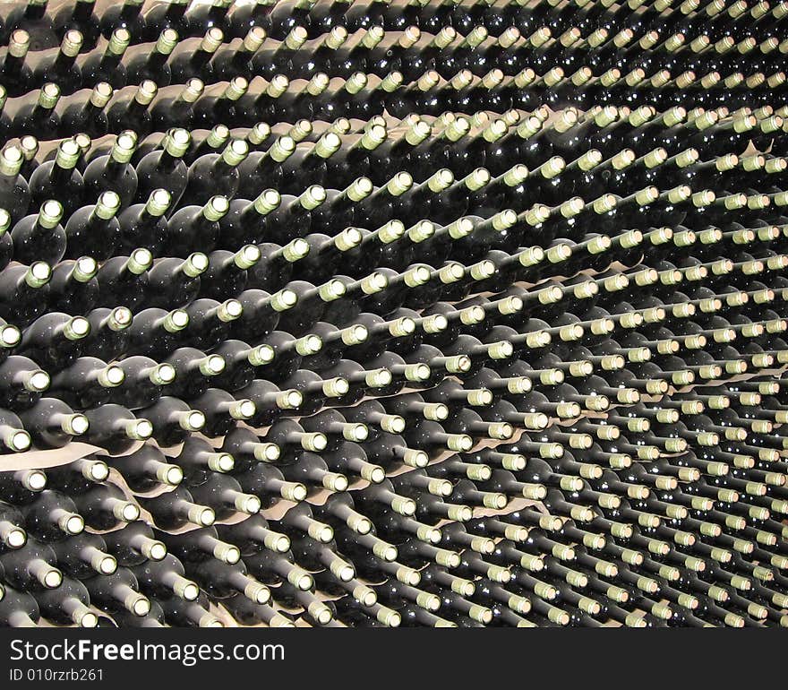 Numerous aging wine bottles stacked in a cellar