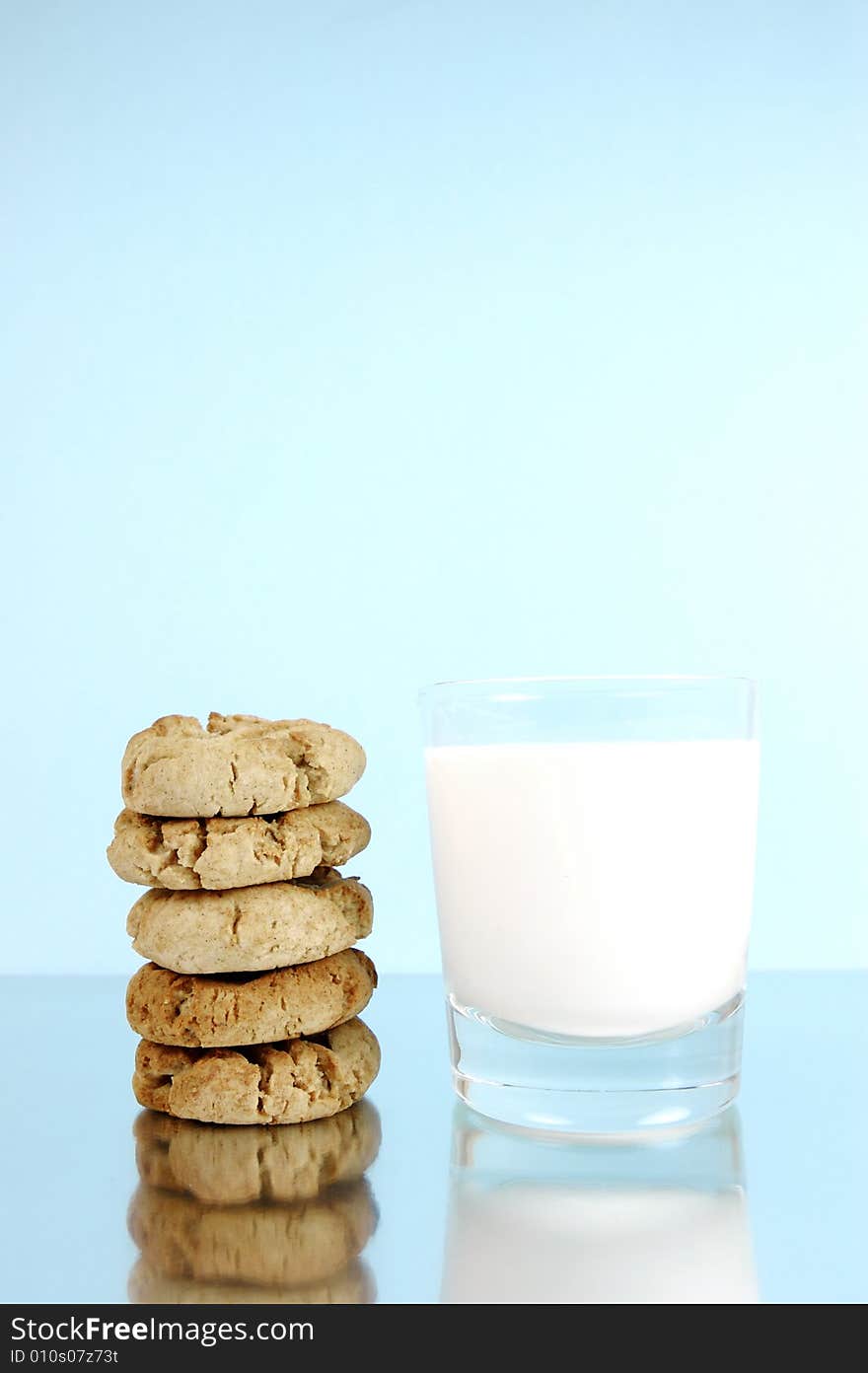 Milk and cookies isolated against a blue background