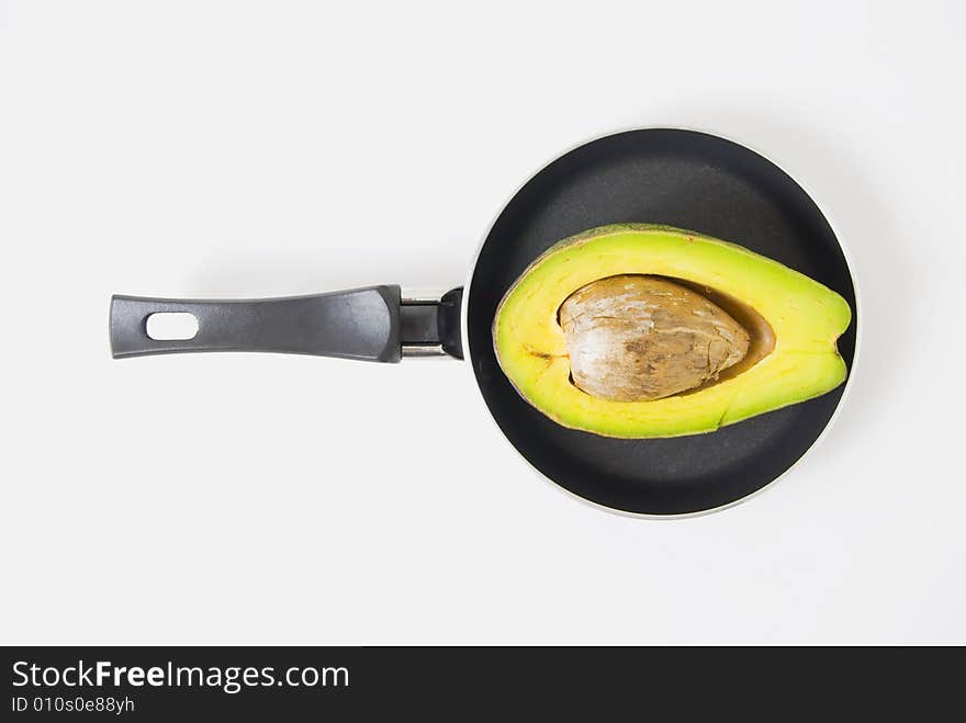 Half avocado on teflon pan