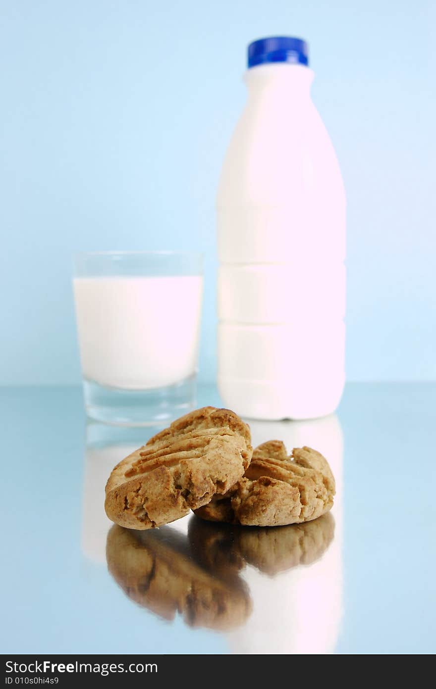 Milk and cookies isolated against a blue background