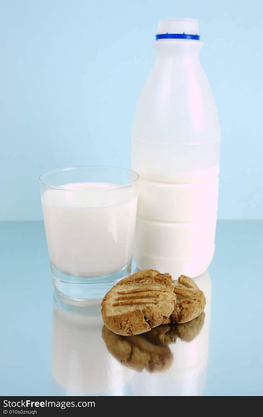 Milk and cookies isolated against a blue background