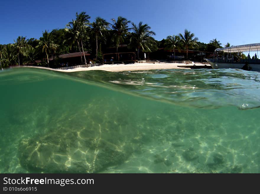 Over / under view of tropical beach