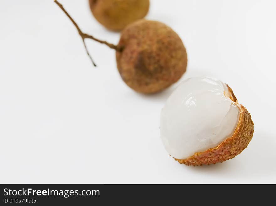 Line of Lychees on white background