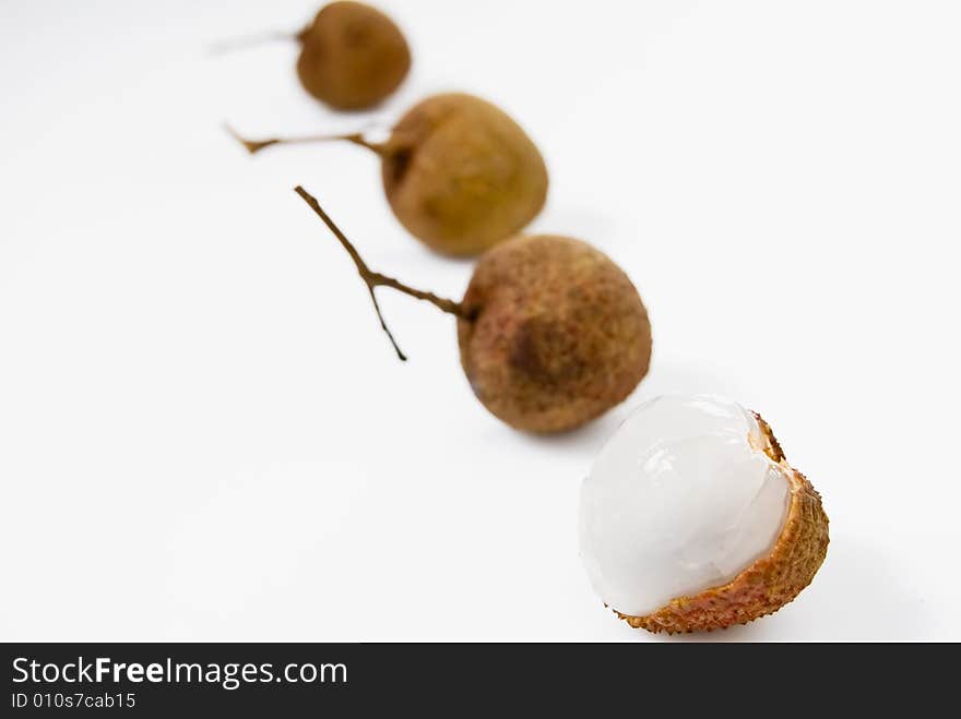 Line of Lychees on white background