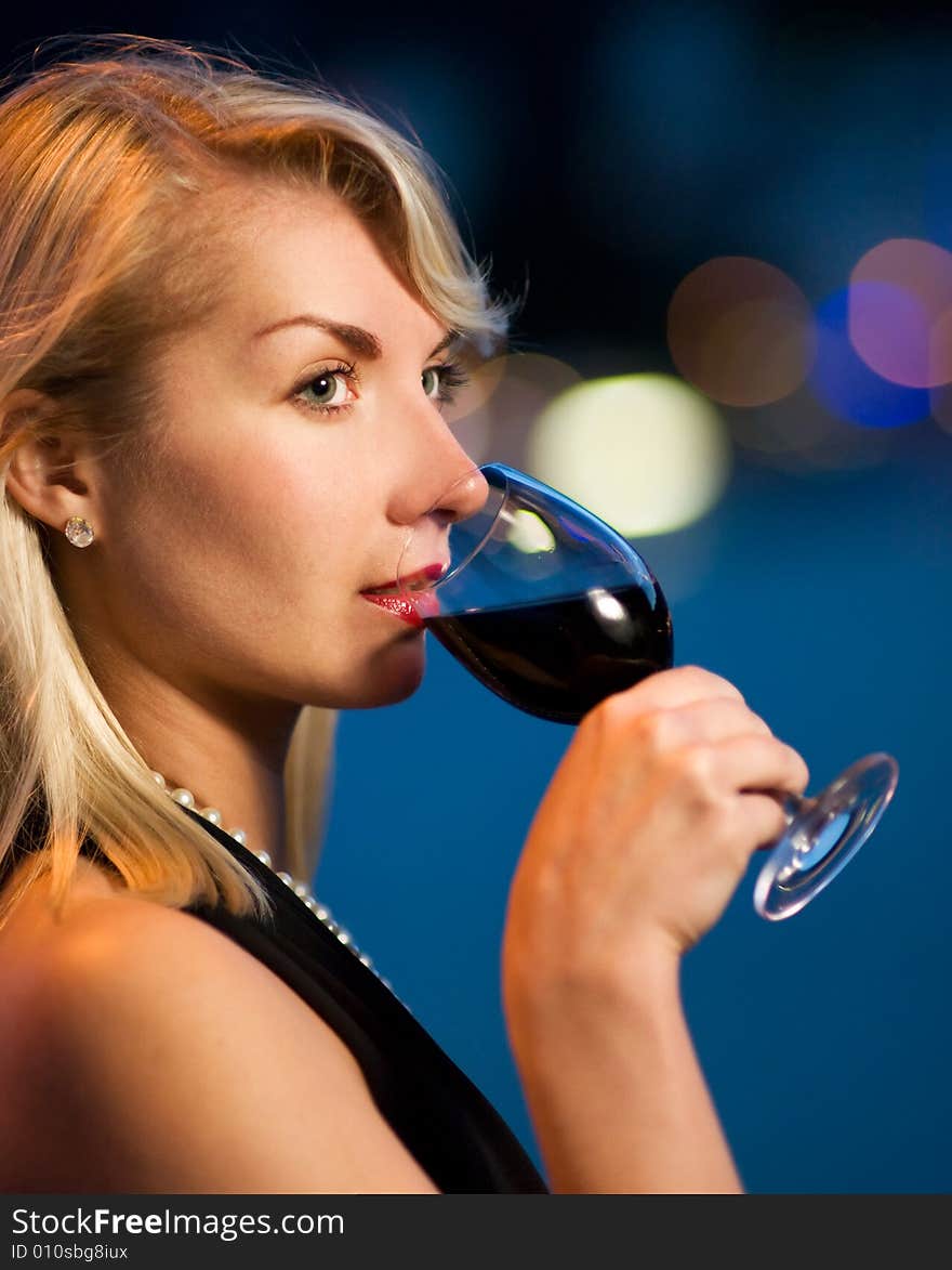 Beautiful young lady drinking red wine