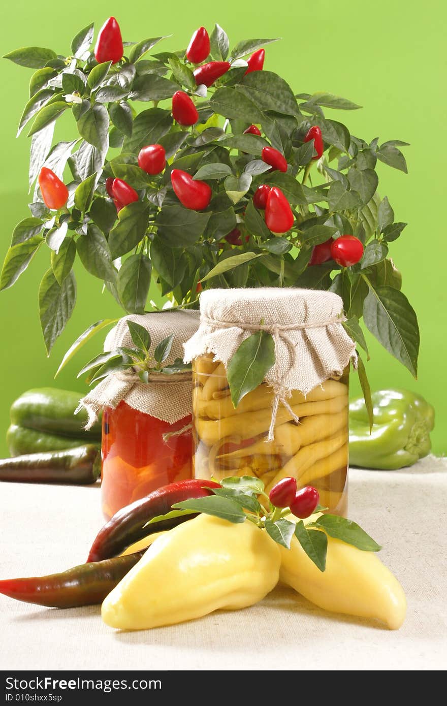 Marinated paprikas in glass jar, with fresh paprikas