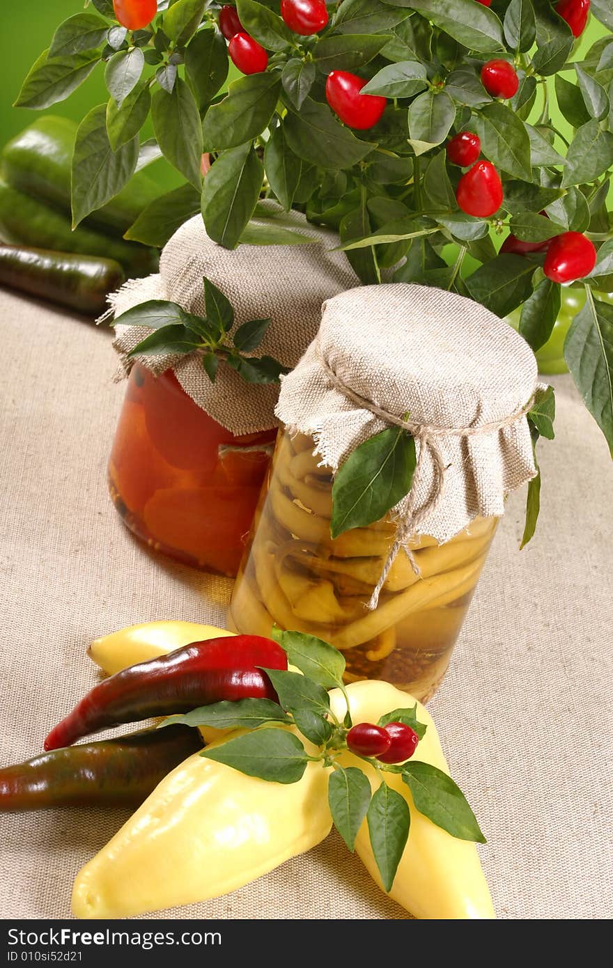 Marinated paprikas in glass jar, with fresh paprikas