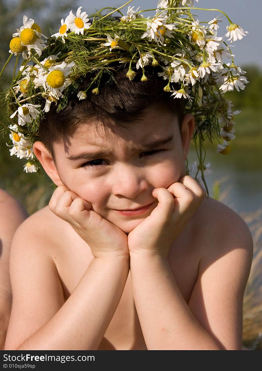 Pensive boy in wreath from daisywheel