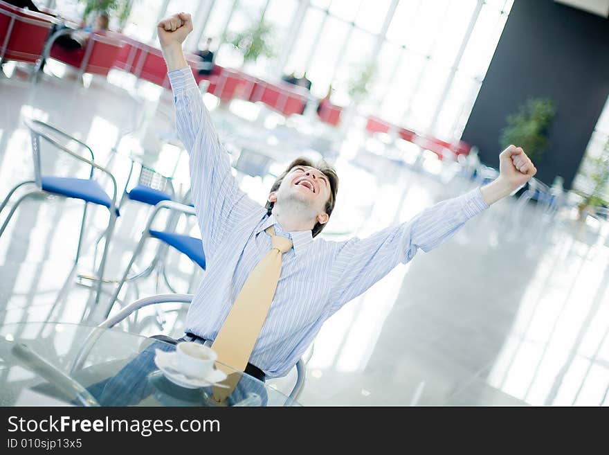 Young happy man at the table