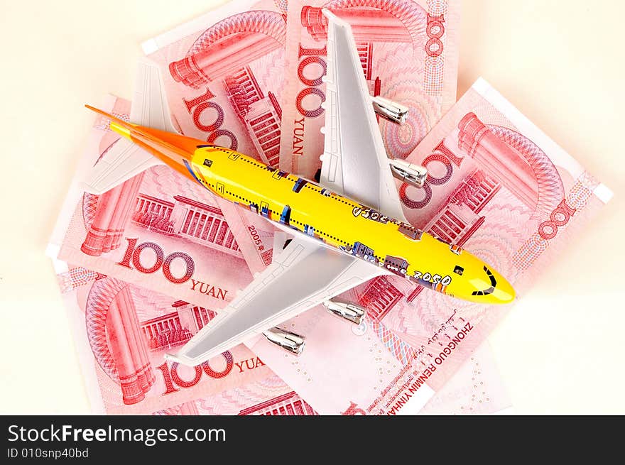 Travel to China... Chinese RMB banknotes and small plane. Travel to China... Chinese RMB banknotes and small plane.