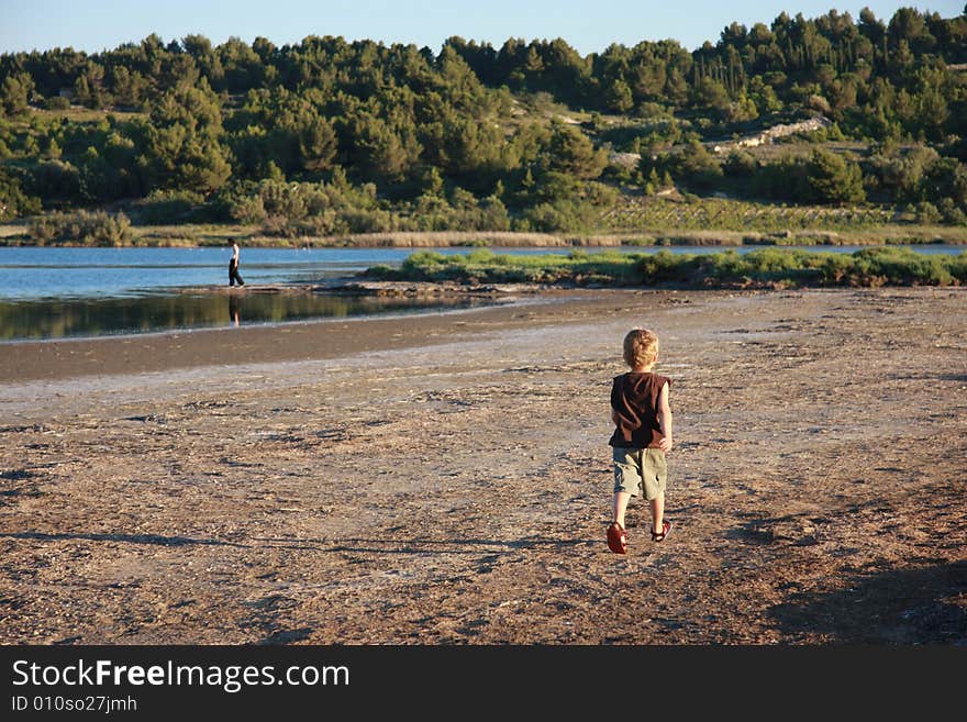 Child running towards his mother in
vineyard country,in the mediterranean. Child running towards his mother in
vineyard country,in the mediterranean.