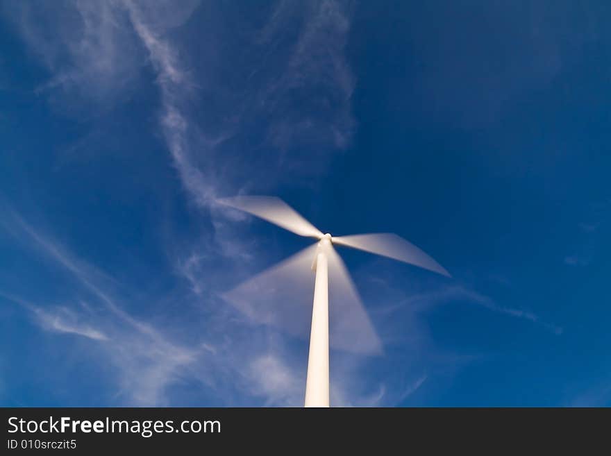 Wind turbine on a blue sky.