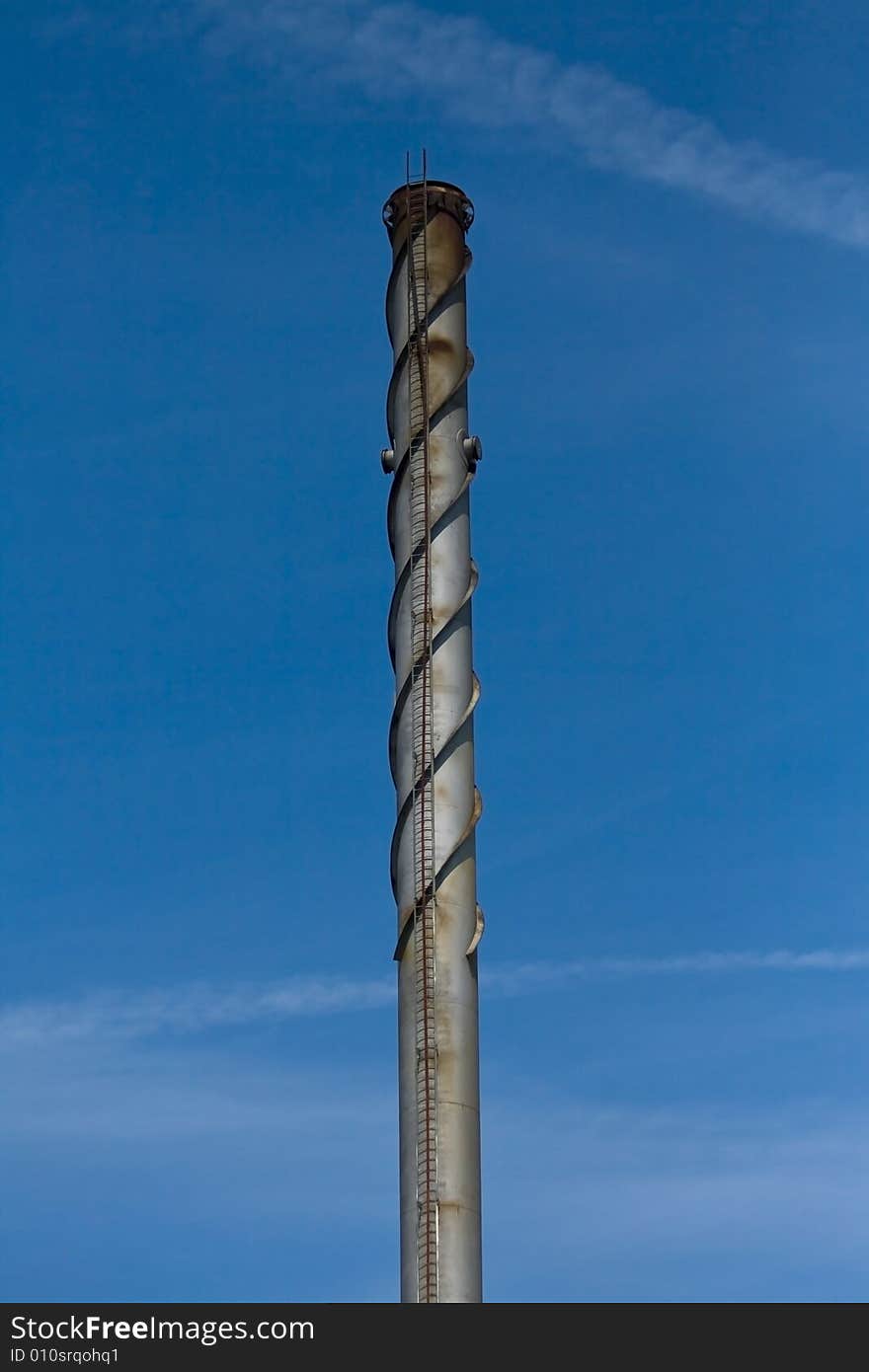 Industrial chimney under a blue sky.