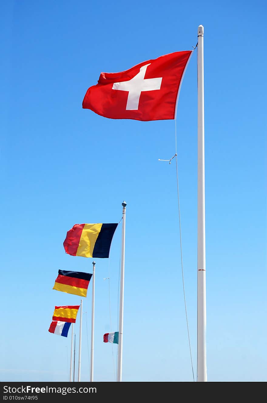 Flags of many countries on the background of bright blue sky