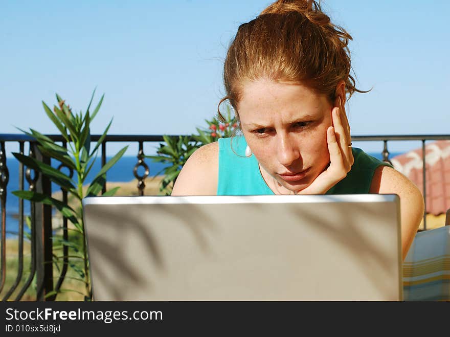 Girl sitting at the terrace with notebook. Girl sitting at the terrace with notebook