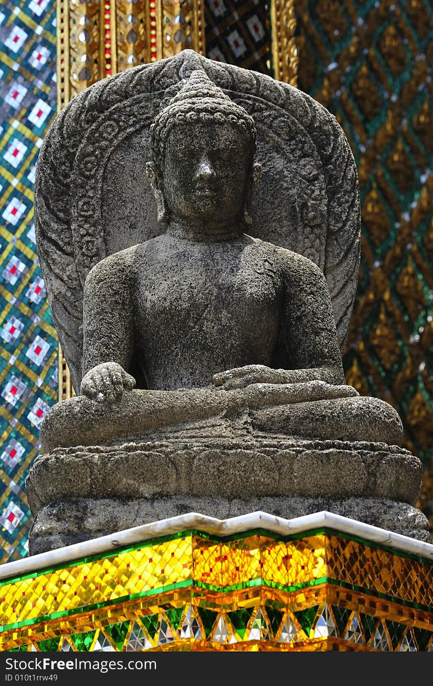 Thailand Bangkok; the wat Phra Kaew shelter the most sacred image of Thailand the Emerald Buddha. The temple is situated in the northeast corner of the Grand Palace. View of a stone seated buddha