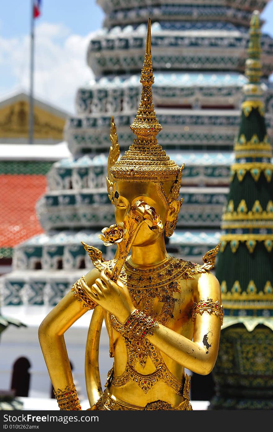 Thailand Bangkok; the wat Phra Kaew shelter the most sacred image of Thailand the Emerald Buddha. The temple is situated in the northeast corner of the Grand Palace. Decorated walls and a golden kannari. Thailand Bangkok; the wat Phra Kaew shelter the most sacred image of Thailand the Emerald Buddha. The temple is situated in the northeast corner of the Grand Palace. Decorated walls and a golden kannari