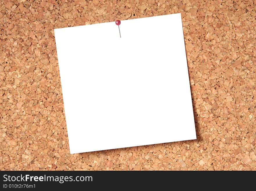 White blank card pinned to a brown cork board