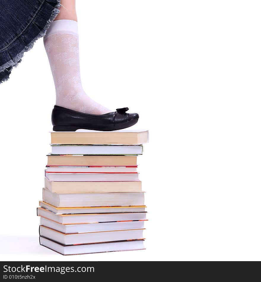 Leg of litlle  girl on the stack of books. Leg of litlle  girl on the stack of books