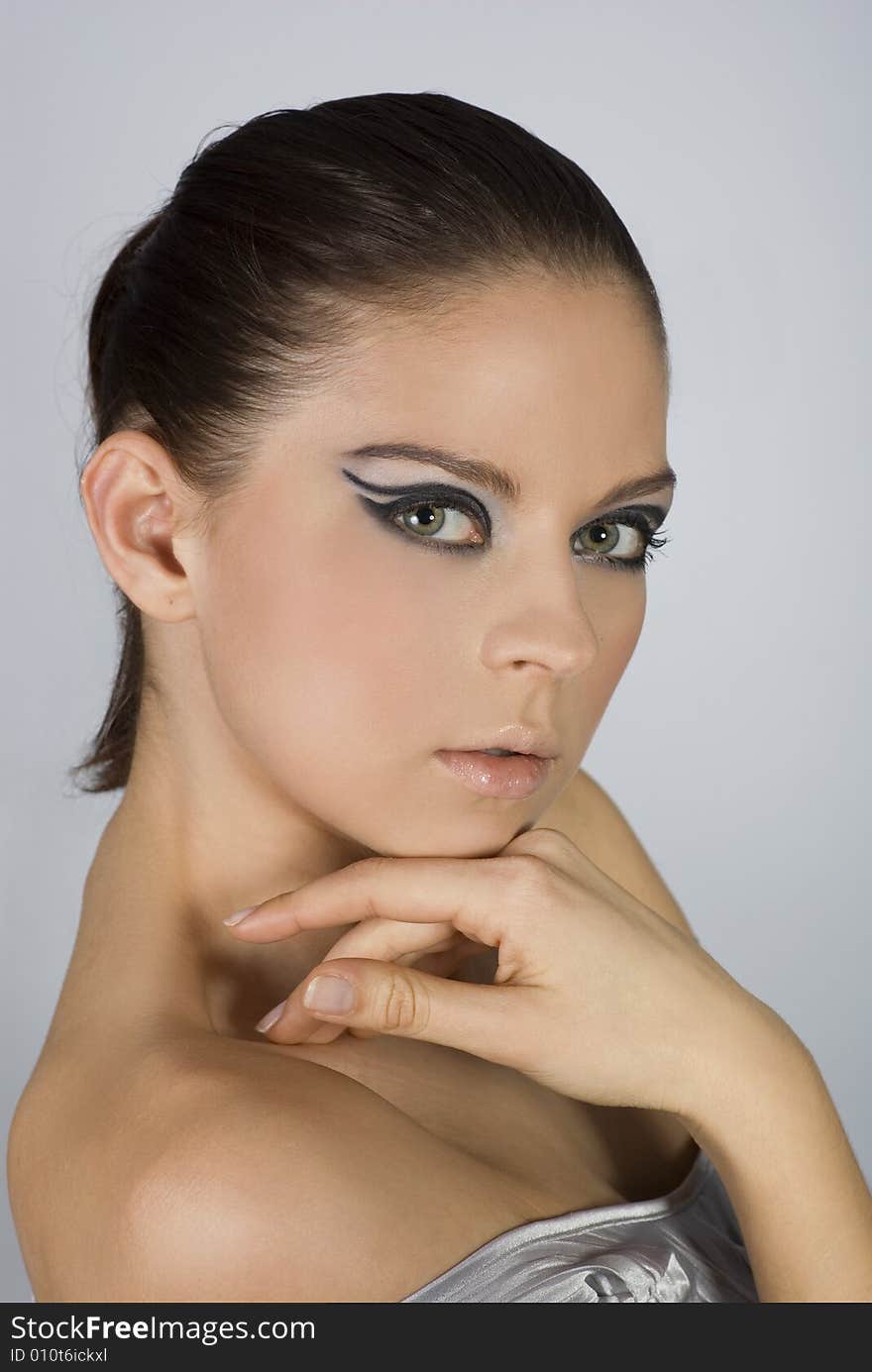 Close-up portrait of beautiful woman with professional makeup.